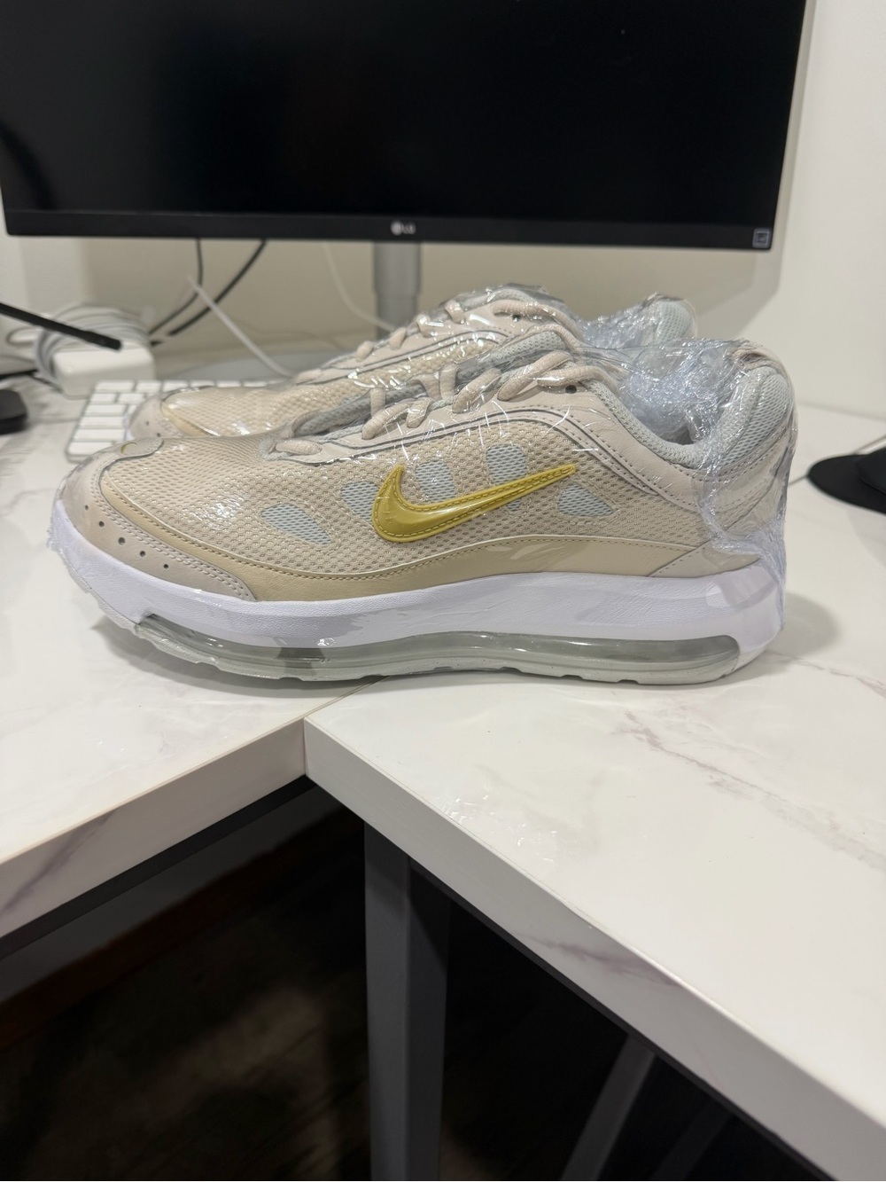 Nike Beige Athletic Sneakers with Gold Swoosh